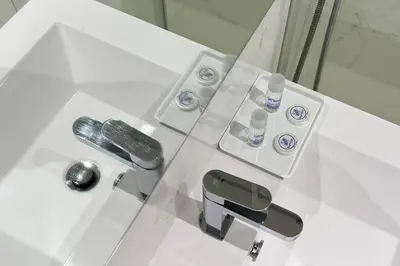 a white bathroom with a sink and a faucet at Antas Park Concept Lifestyle With Pool in Porto