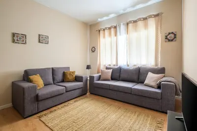 a living room with two couches and a window at Spacious 3 BRs Apartment, steps to Joao's station in Vila Nova de Gaia