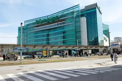a large glass building with people walking in front of it at Spacious 3 BRs Apartment, steps to Joao's station in Vila Nova de Gaia