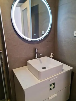 a bathroom with a white sink and a mirror at Campanhã - Studio A in Porto