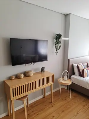 a living room with a television on a wall at Campanhã - Studio A in Porto