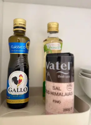 two bottles of alcohol and a can on a shelf at The Arcada House by MyMoradia in Porto