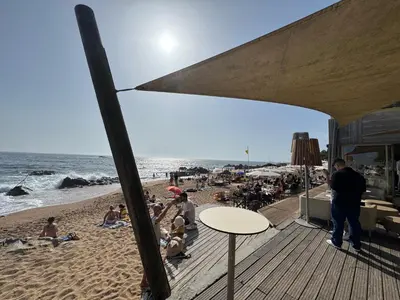 a group of people sitting on the beach at The Arcada House by MyMoradia in Porto