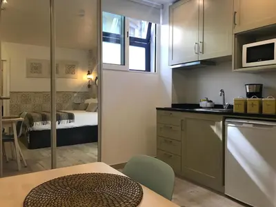 a small kitchen with a room with a bed at Porto Náutico & Spa in Porto