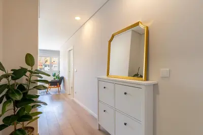 a bedroom with a dresser with a mirror on it at HostWise - Modern Flat in Boavista in Porto