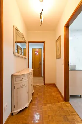 a hallway with a mirror and a wooden floor at Aposentus - Antas Heaven in Porto