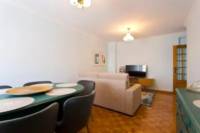 a living room with a table and chairs and a couch at Aposentus - Antas Heaven in Porto