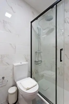 a bathroom with a toilet and a glass shower at Aposentus - Antas Heaven in Porto