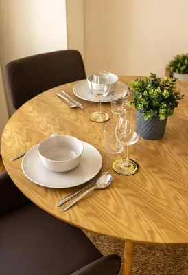 a wooden table with plates and wine glasses on it at Central charming flat SÉ by casaporto207 in Porto