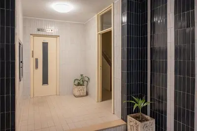 a bathroom with black and white tiles and a door at Aposentus - Cest La Vie in Porto