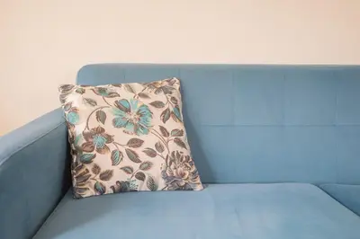 a blue couch with a flower pillow on it at Aposentus - Cest La Vie in Porto