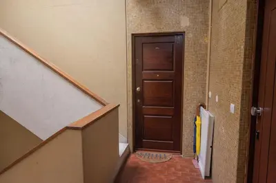 a hallway with a wooden door and a staircase at Aposentus - Cest La Vie in Porto