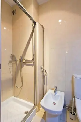 a bathroom with a shower and a toilet and a sink at APOSENTUS - The Palazzo in Porto