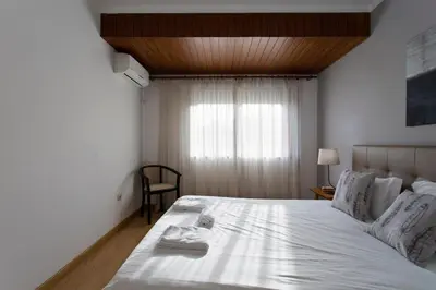 a bedroom with a white bed with towels on it at APOSENTUS - The Palazzo in Porto