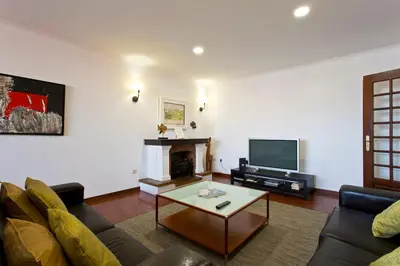 a living room with a couch and a tv at APOSENTUS - The Palazzo in Porto