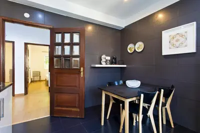 a dining room with a wooden table and chairs at APOSENTUS - Serenity 2E in Porto