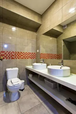 a bathroom with two sinks and a toilet at APOSENTUS - Serenity 2E in Porto