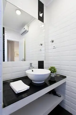 a white bathroom with a sink and a mirror at APOSENTUS - The First in Porto
