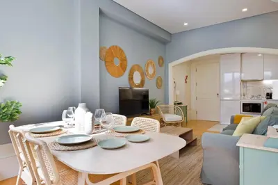 a dining room and living room with a table and chairs at Aposentus - Formosa Boutique in Porto
