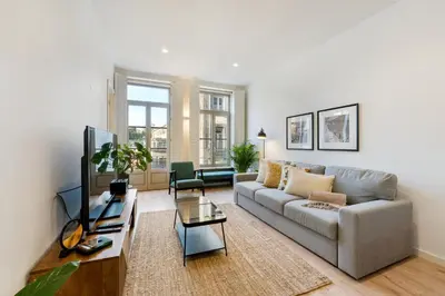 a living room with a couch and a tv at GuestReady - A lovely stay in Rua da Boavista in Porto