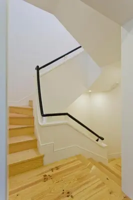 a stairwell with a white wall and a window at APOSENTUS - Porto's Charming Apartment in Porto