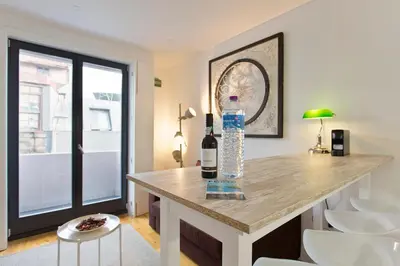 a room with a table with a bottle of wine at APOSENTUS - Porto's Charming Apartment in Porto