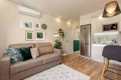 a living room with a couch and a kitchen at Porto Luxury II in Porto