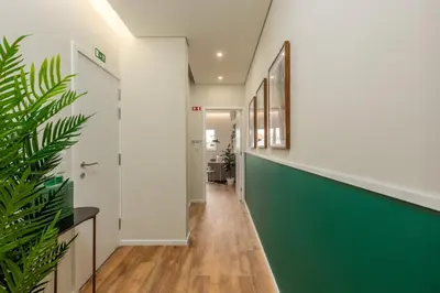 a hallway of a house with a green wall at Porto Luxury II in Porto