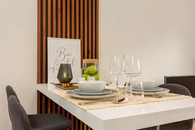 a dining room table with plates and wine glasses at Porto Luxury II in Porto