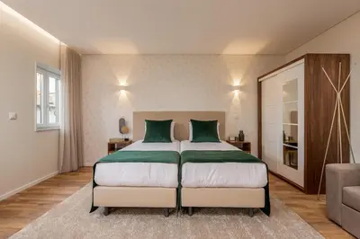 a bedroom with a large bed and a couch at Porto Luxury II in Porto