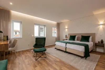 a bedroom with a bed and a desk and a chair at Porto Luxury II in Porto