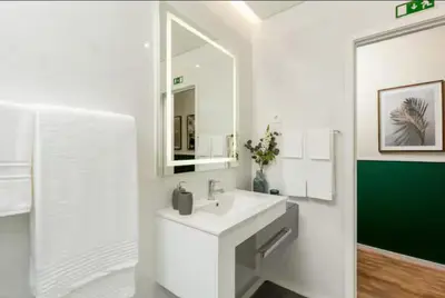 a white bathroom with a sink and a mirror at Porto Luxury II in Porto