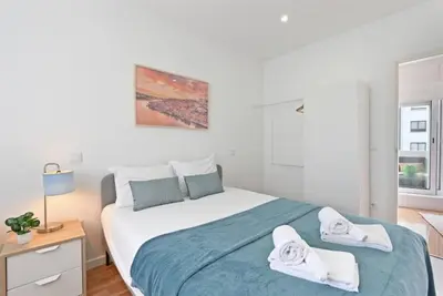 a bedroom with a large bed with towels on it at Apartamento Ponte D Luís in Vila Nova de Gaia