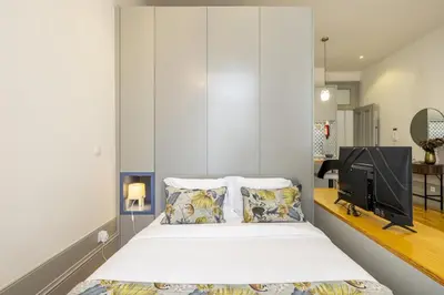 a bedroom with a bed and a tv in a room at 741 Studio By D&S in Porto
