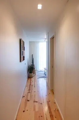 an empty hallway with a wooden floor in a house at ORM - Cedofeita II Apartment in Porto