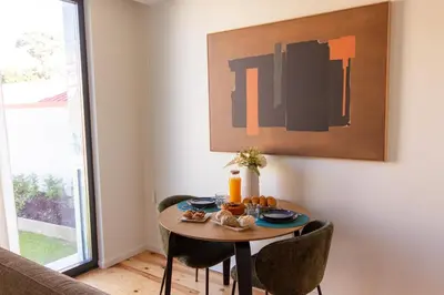 a table in a living room with a table and chairs at ORM - Cedofeita II Apartment in Porto