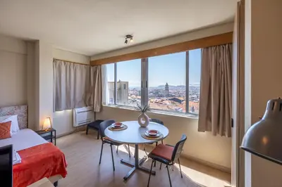 a hotel room with a bed and a table and a window at Skyline Porto Apartment - Porto Velho Apt in Porto