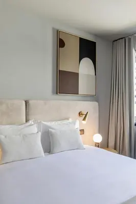 a white bed with white pillows in a bedroom at Regras Apartments & Garden by Benefit Collection B in Porto
