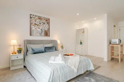 a bedroom with a bed with a tray of fruit on it at HostWise - Modern & Bright Studio in Porto