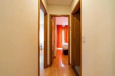 a hallway leading to a room with a bed in a room at O'Porto Main Street St Catarina 1 in Porto