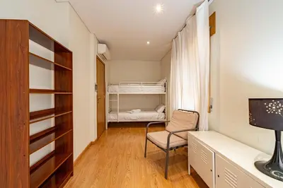 a small room with a chair and a bed at O'Porto Main Street St Catarina 1 in Porto
