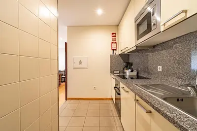 a kitchen with a sink and a microwave at O'Porto Main Street St Catarina 1 in Porto