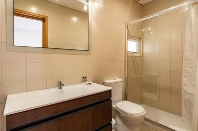 a bathroom with a sink and a toilet and a mirror at O'Porto Main Street St Catarina 2 Studio Apartment in Porto