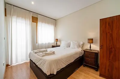 a bedroom with a large bed and a window at O'Porto Main Street St Catarina 2 DOWNTOWN in Porto