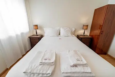 a bedroom with a bed with two towels on it at O'Porto Main Street St Catarina 2 DOWNTOWN in Porto