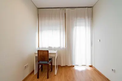 a room with a desk and a chair and a window at O'Porto Main Street St Catarina 2 DOWNTOWN in Porto