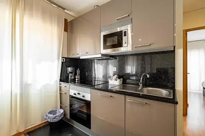 a kitchen with a sink and a microwave at O'Porto Main Street St Catarina 2 DOWNTOWN in Porto