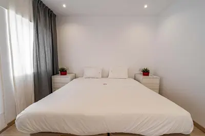 a large white bed in a room with a window at O'Porto Main street St Catarina 3 Rooftop in Porto
