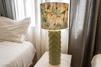 a lamp sitting on a table next to a bed at O'Porto Main street St Catarina 3 Rooftop in Porto