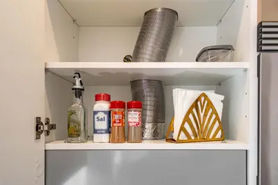 a shelf in a kitchen with condiments and bottles at O'Porto Main street St Catarina 3 Rooftop in Porto